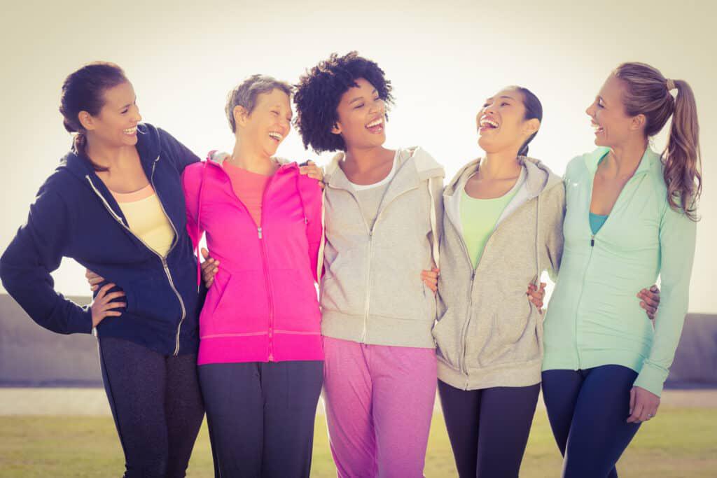 Looking for things to do in Sugar Land? Check out this group of women standing together and laughing.