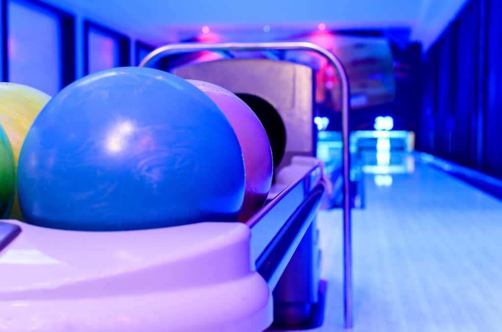 A bowling ball on a rack.