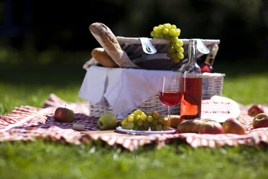 A picnic basket with fruit and wine, perfect for a relaxing outing in Brooklyn.