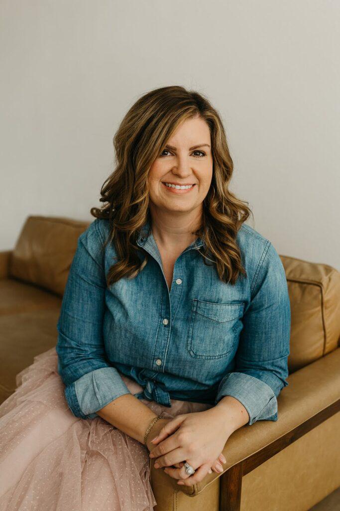 Woman smiling and sitting on couch