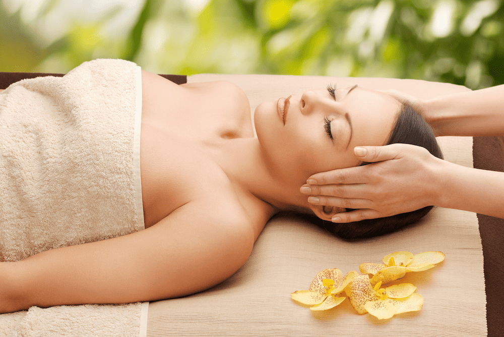 A woman enjoying a tranquil massage at a serene spa.
