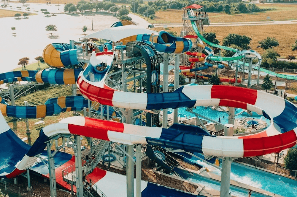 An aerial view of a water park with several water slides.