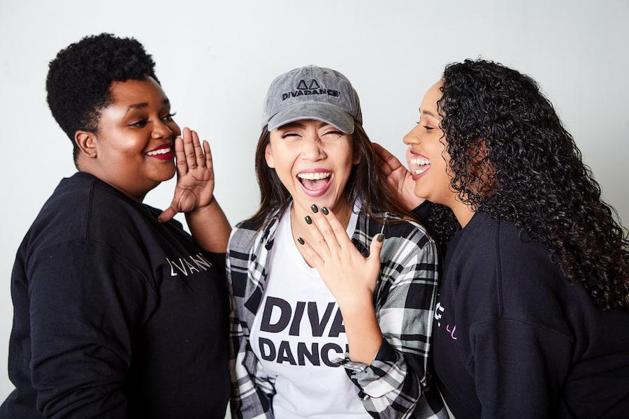 Three Diverse Women Whispering and Laughing