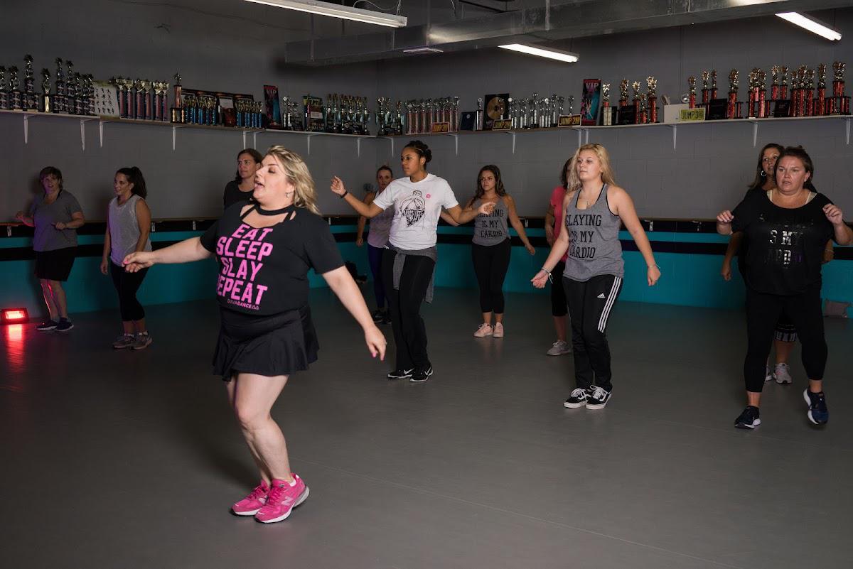 Members following an instructor during a DivaDance choreography class in a mirrored studio