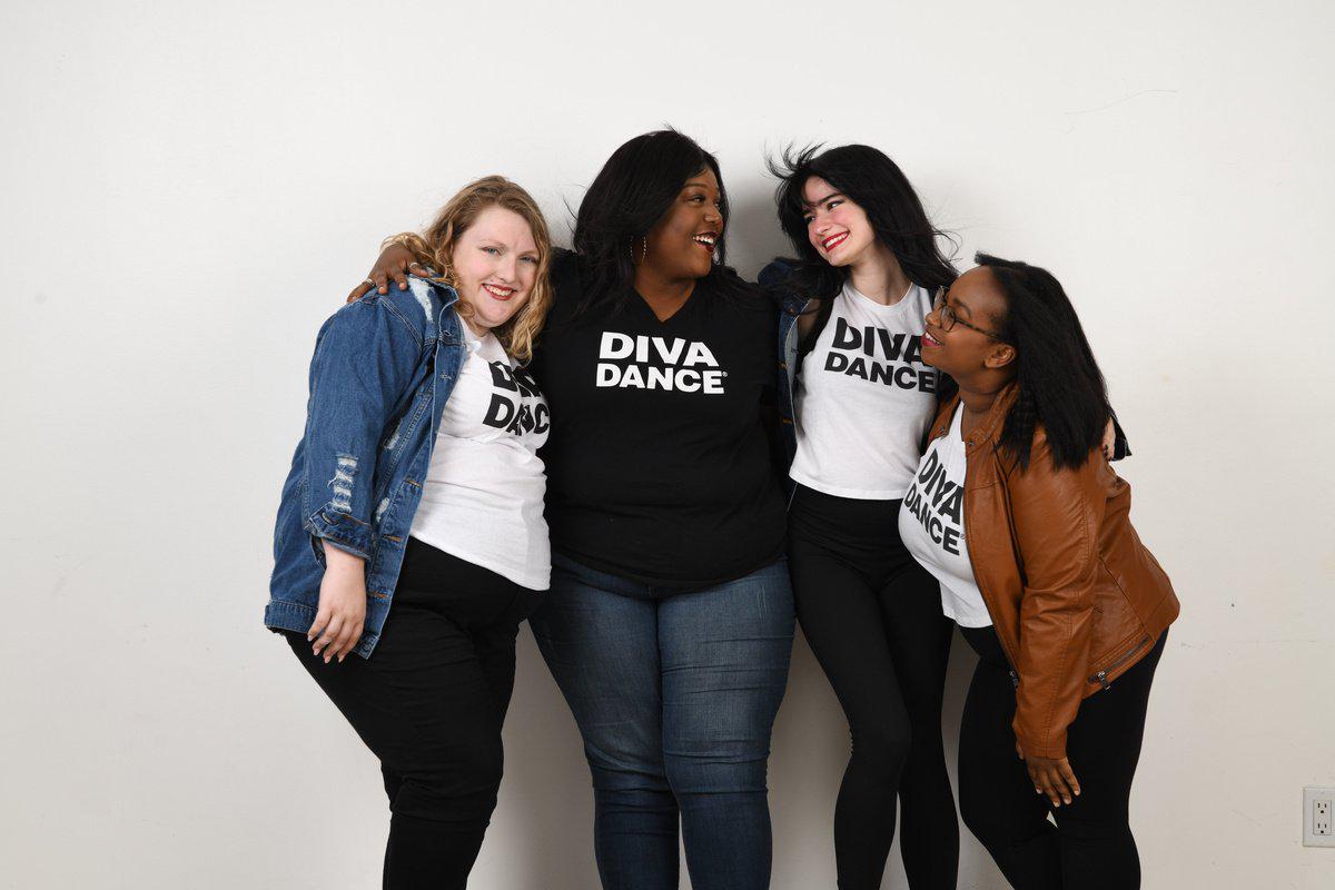 Group of four adult women friends arm in arm in DivaDance shirts